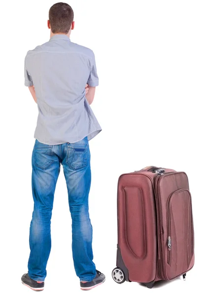 Back view of young man traveling with suitcase. — Stock Photo, Image