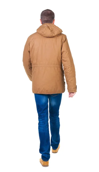 Back view of going handsome man in brown parka. — Stock Photo, Image