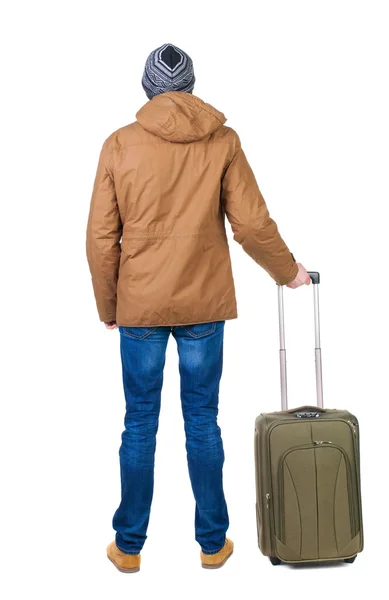 Back view of man in a brown jacket with suitcase . – stockfoto