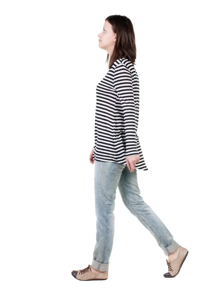 Back view of walking woman in jeans . — Stock Photo, Image