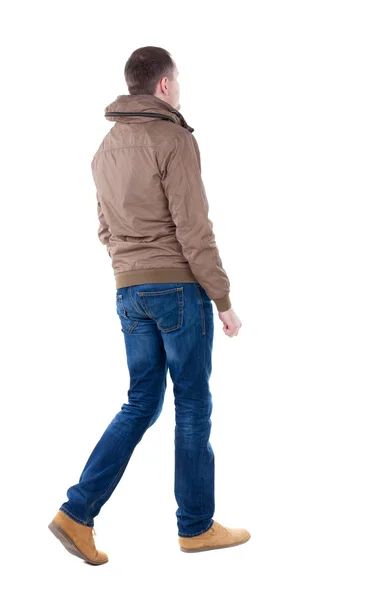 Back view of going handsome man in brown wind breaker — Stock Photo, Image