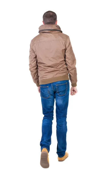 Back view of going handsome man in brown wind breaker — Stock Photo, Image