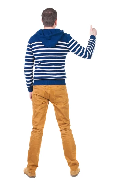 Zadní pohled na člověka v svetr ukazuje palec. — Stock fotografie