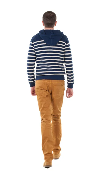 Вернуться мнение идти красивый мужчина в джинсах и полосатый свитер. — стоковое фото
