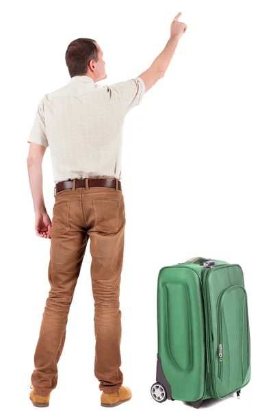 Vista posterior de señalar a hombre joven viajando con maleta. — Foto de Stock