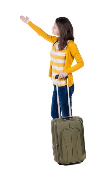 Woman with suitcase pointing — Stock Photo, Image