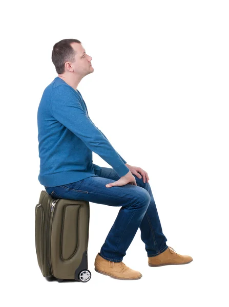 Man sitting on a suitcase — Stock Photo, Image