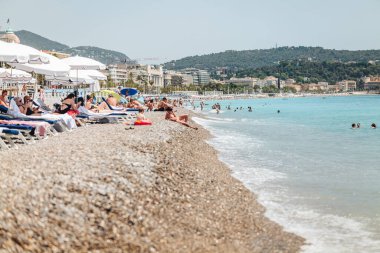 Nice, France-June 2022: life by The beautiful stone beach