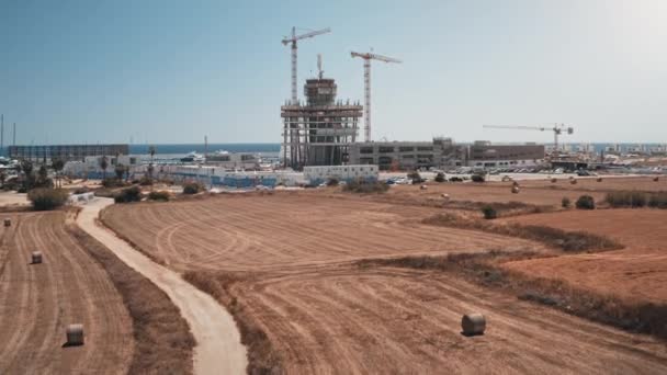 Desarrollo de infraestructuras en el campo. Camino de los campos rurales en el pasado a la ciudad costera futurista — Vídeo de stock