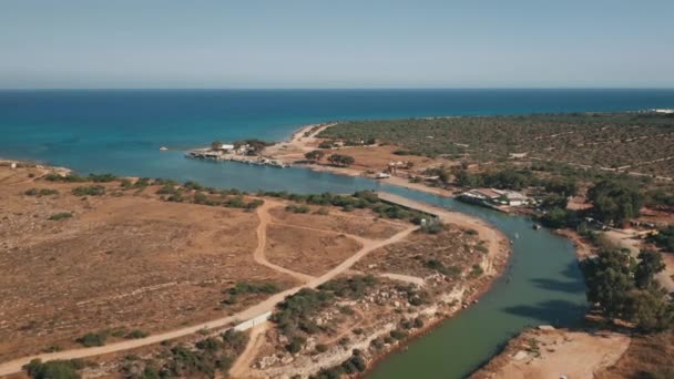 Вода морської затоки тече в річці в сухій пустелі. Повітряний політ над посухою сільської берегової лінії річки — стокове відео