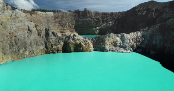 Uma cratera vulcânica Lagos Kelimutu com closeup de água azul-turquesa. Voo aéreo sobre o aqua azul — Vídeo de Stock