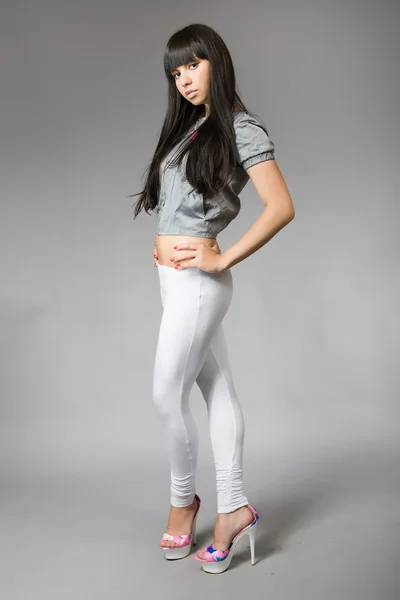 Jovem mulher com cabelo preto e leggings brancos — Fotografia de Stock