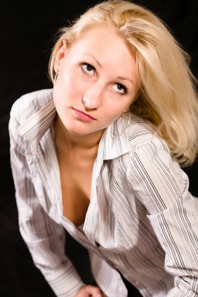 Blonde in a striped shirt on a black background — Stock Photo, Image