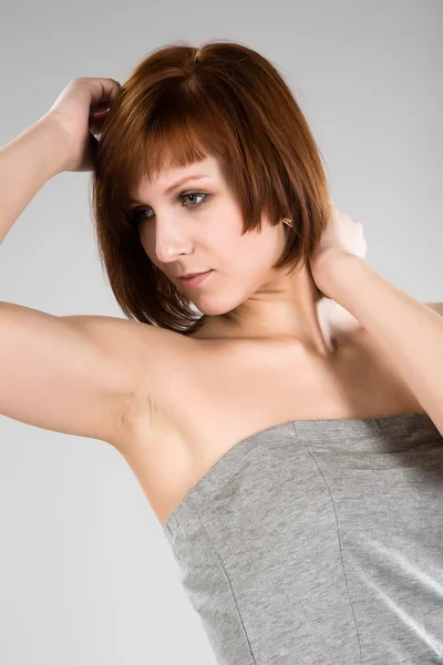Krásná brunetka v šedá halenka — Stock fotografie