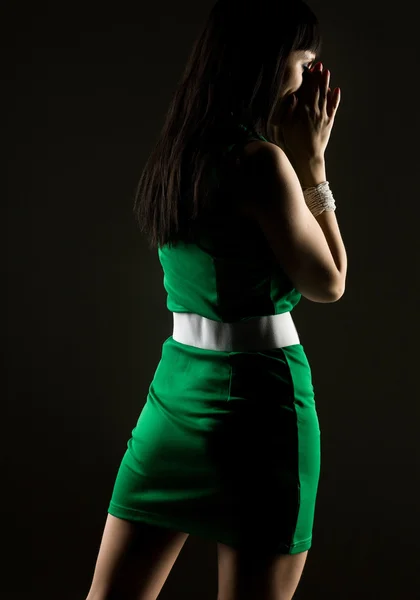 Young woman on a black background — Stock Photo, Image