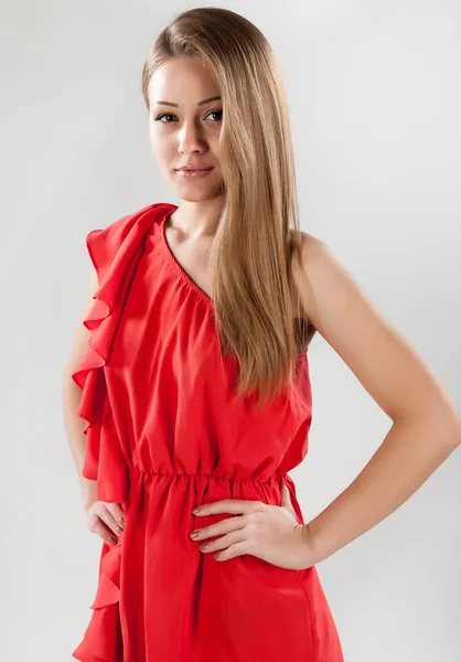 Attractive girl in a red dress — Stock Photo, Image