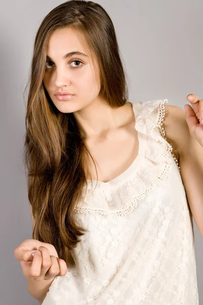 Long-haired girl on gray background — Stock Photo, Image