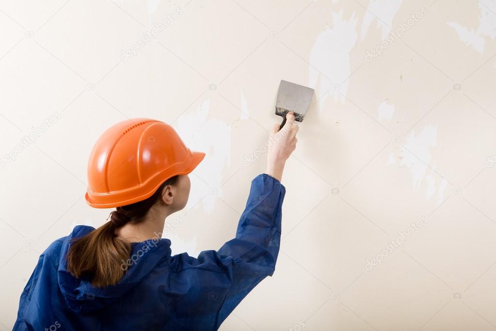 worker removes old wallpaper