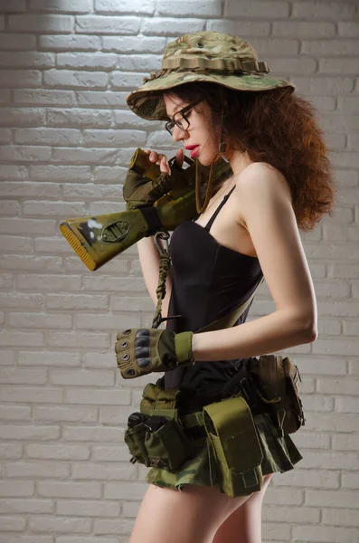 Sexy girl military soldier in short skirt with automatic rifle for airsoft — Zdjęcie stockowe