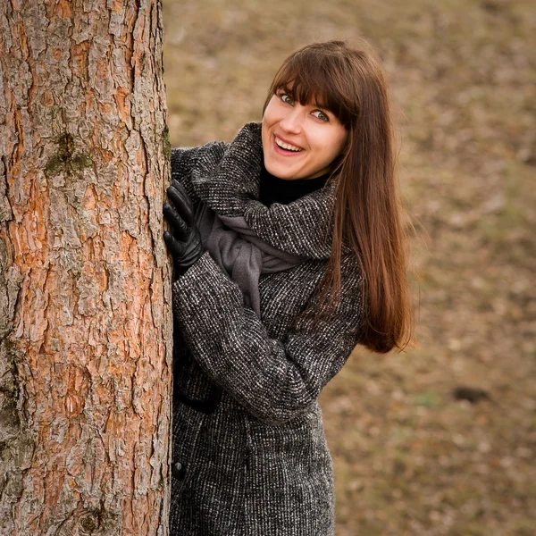 Beautiful woman behind the tree