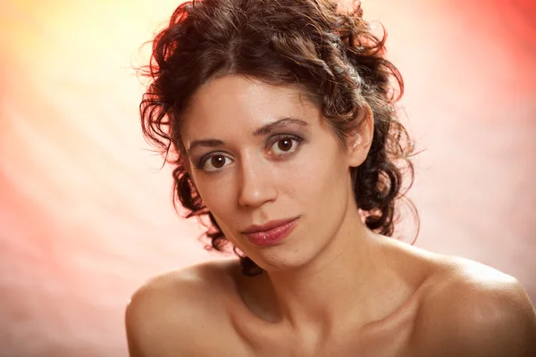 Portrait of the young dark-haired girl in studio on color backgr — Stock Photo, Image