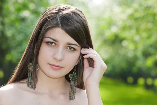 The long-haired girl against blossoming apple-trees. — Stock Photo, Image