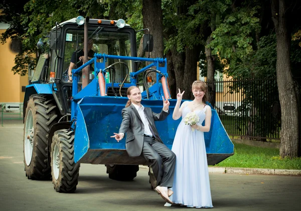 Novomanželé na traktoru v parku — Stock fotografie