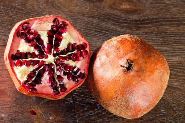 Pomegranate on a wooden table — Stock Photo, Image