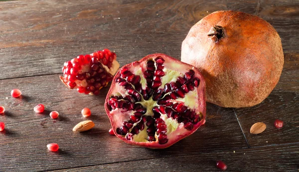 Pomegranate on a wooden table — Stock Photo, Image