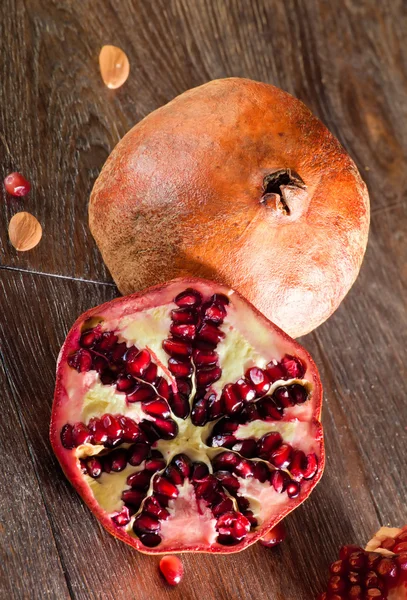 Pomegranate on a wooden table — Stock Photo, Image