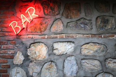Bar sign on a stone wall clipart