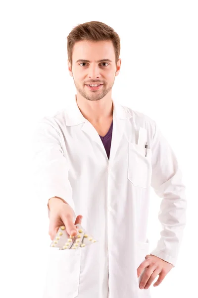 A young doctor holding some pills — Stock Photo, Image