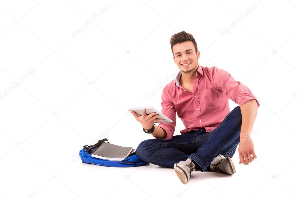 Young happy student working with a new digital tablet computer