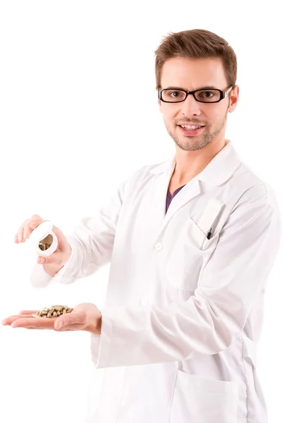 A young doctor holding some pills — Stock Photo, Image