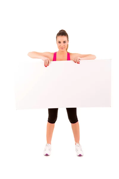 Sport fitness vrouw houd leeg bord — Stockfoto