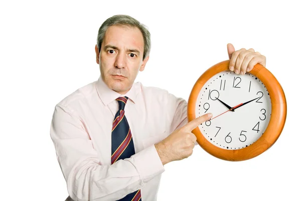 Mature handsome businessman holding a clock — Stock Photo, Image