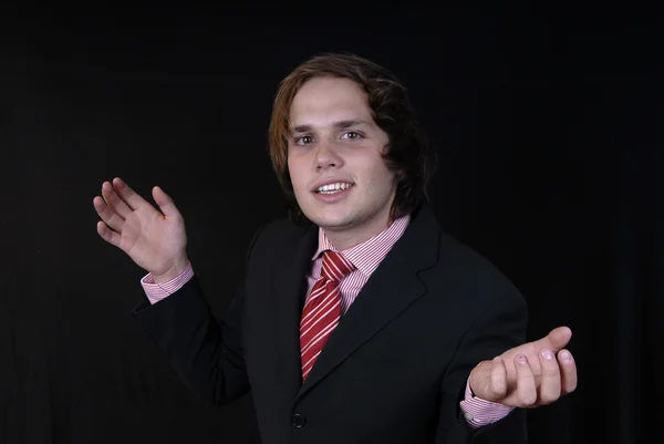 Young businessman portrait on black background — Stock Photo, Image