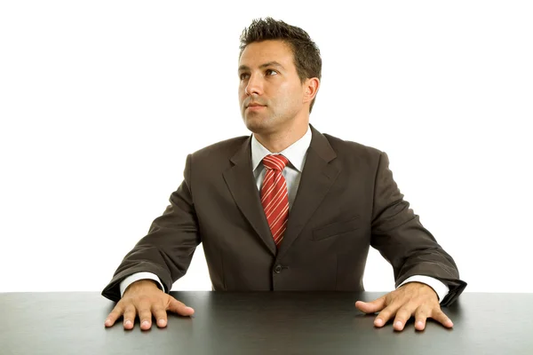 Thinking young business man on a desk — Stock Photo, Image