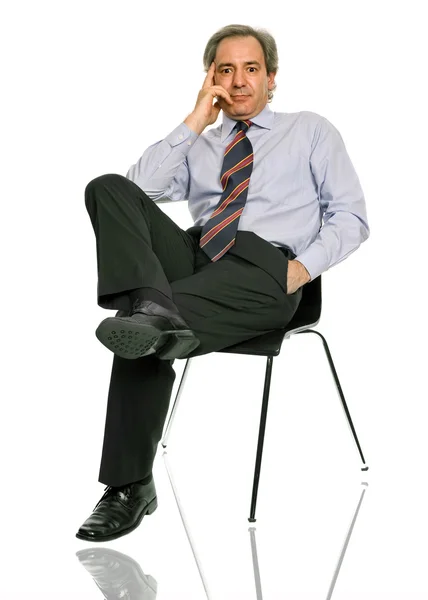 Mature businessman on a chair — Stock Photo, Image