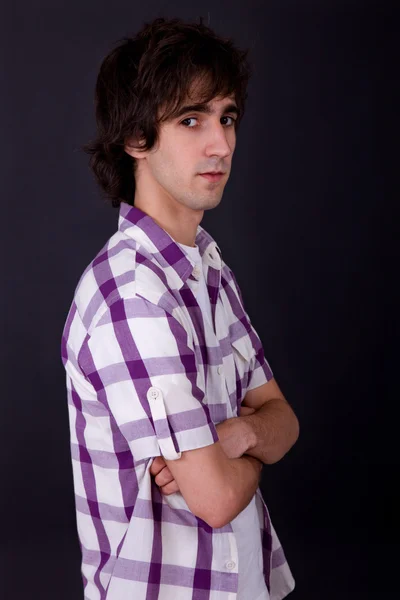 Young casual man against a black background Stock Image