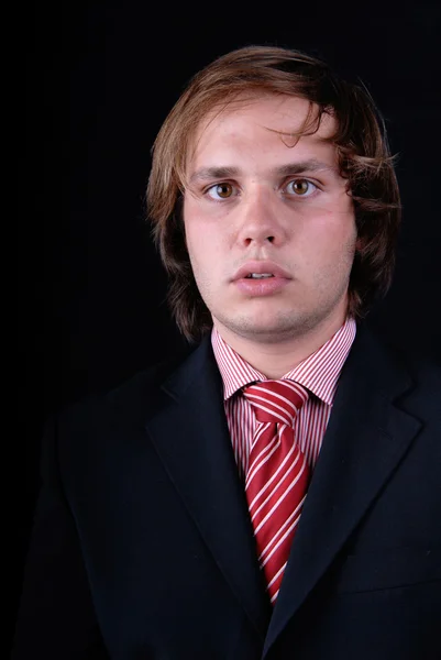 Joven hombre loco retrato sobre fondo negro — Foto de Stock