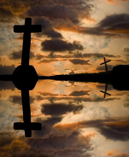 Cross silhouette and the clouds at sunset — Stock Photo, Image