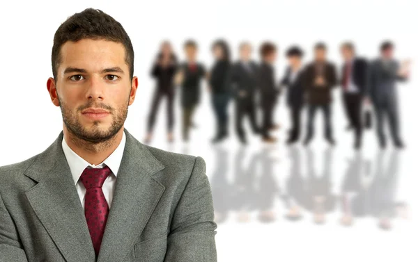 Young business man in front of a group of — Stock Photo, Image