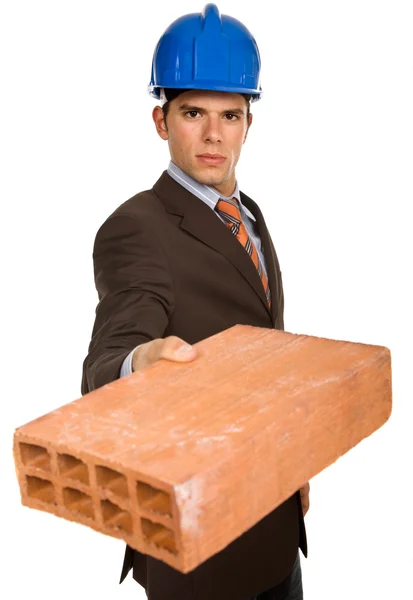 Young business man with a brick, on white — Stock Photo, Image