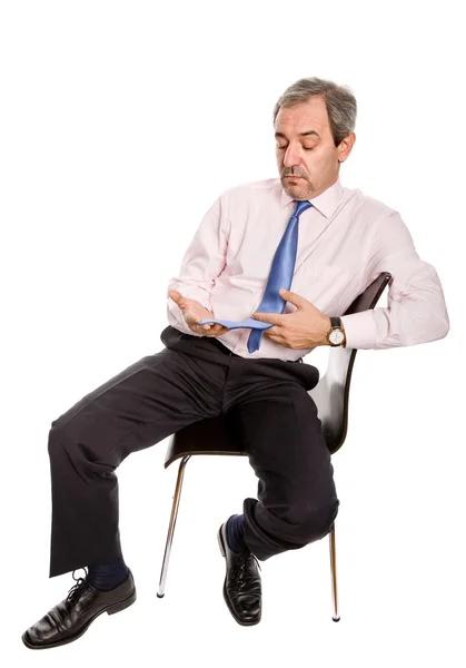 Preocupado hombre de negocios maduro en una silla —  Fotos de Stock