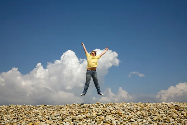 Young man jumps on beach — Stock Photo, Image