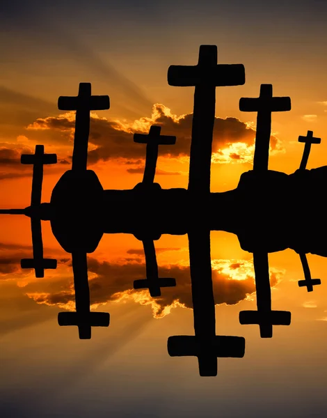 Kreuz bei Sonnenuntergang und den orangen Wolken — Stockfoto