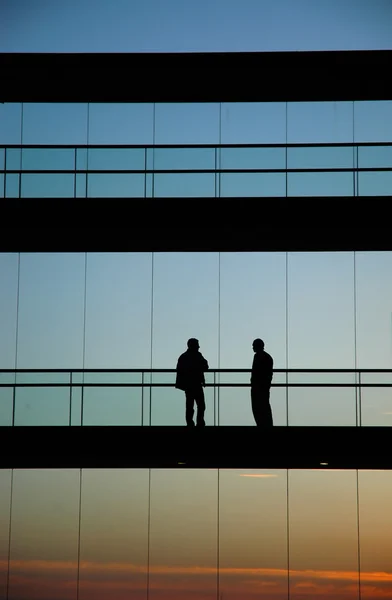 Two workers inside the building silhouette — Stock Photo, Image