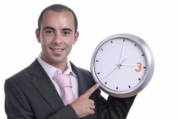 Um homem de negócios bonito segurando um relógio — Fotografia de Stock