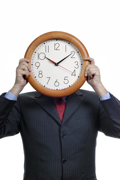 Caucasian man wearing suit holding clock in the head — Stock Photo, Image